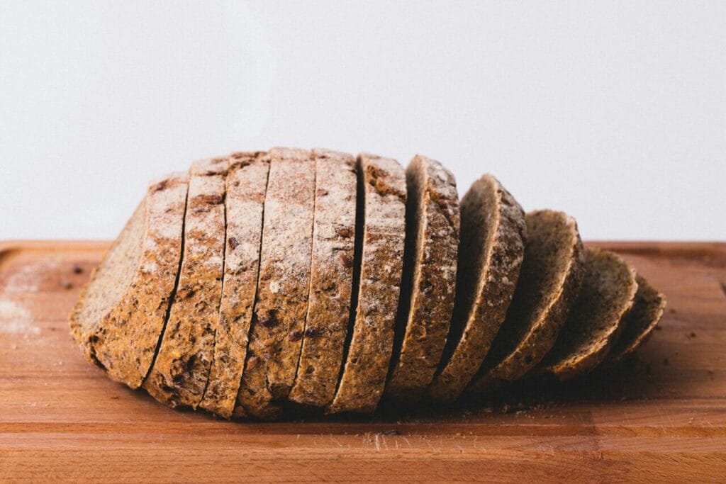 Why Do I Feel Bloated After Eating Bread? A loaf of bread on a cutting board